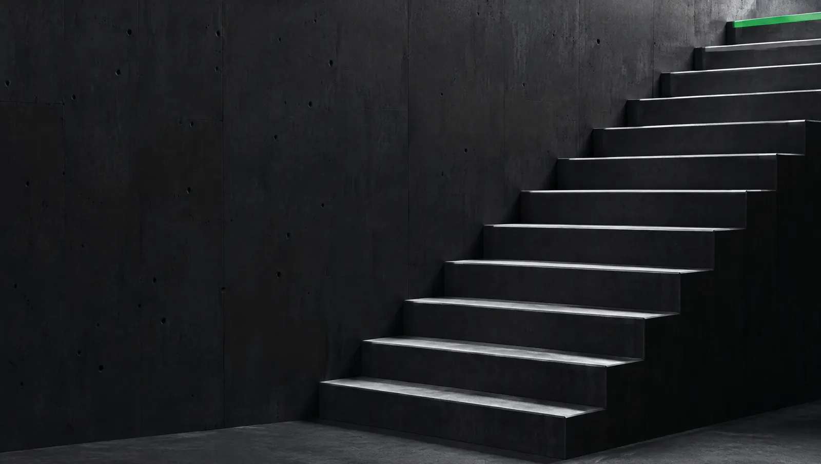 A concrete staircase of identical steps, the top edge green